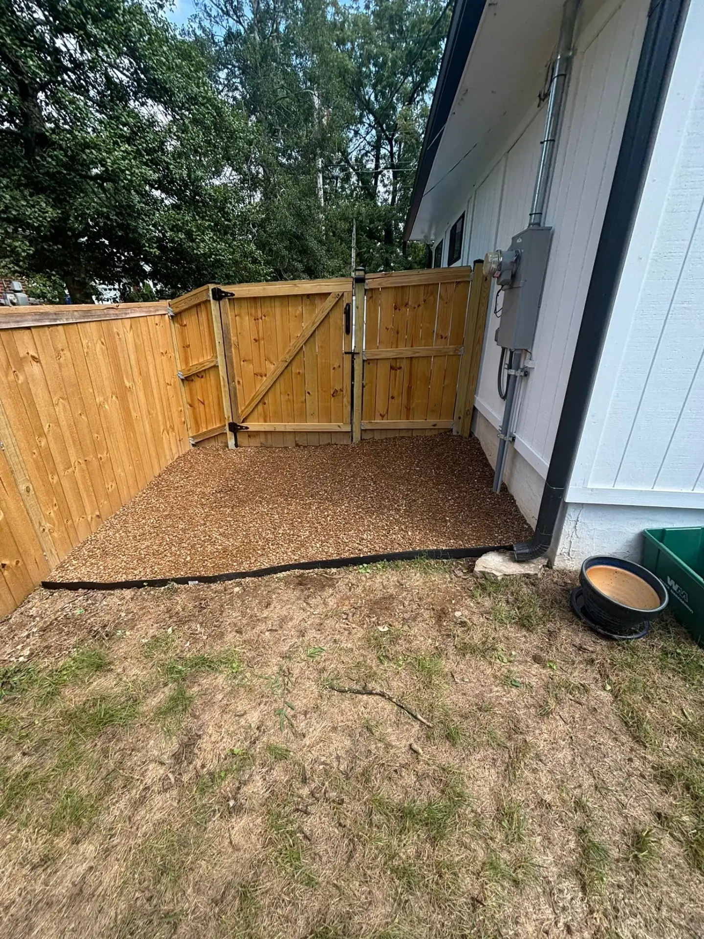 Finished privacy fence with gravel side yard installed by J&W Builds
